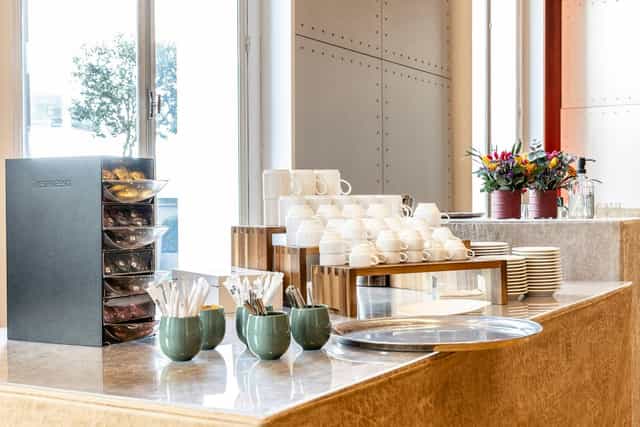 Salon De La Vaulx refreshment station with coffee and pastries for networking events.