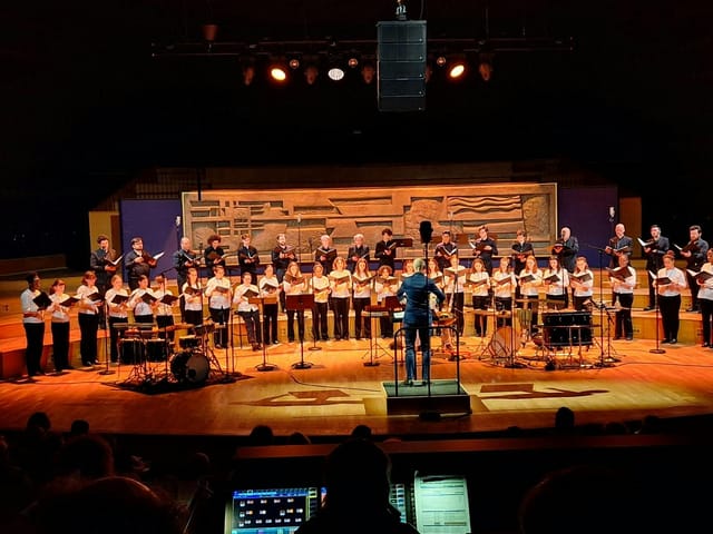 Diverse choir performing on stage at Maison de la Radio, showcasing live music events.