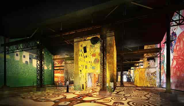 Vibrant Atelier des Lumières space with colorful murals, ideal for art events and meetings.