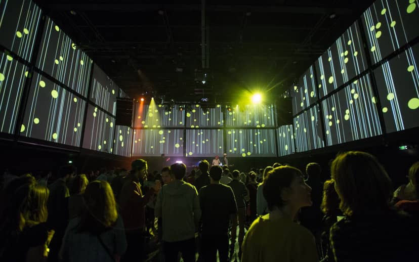 Concert hall at La Gaîté Lyrique with dynamic projections for engaging networking events.