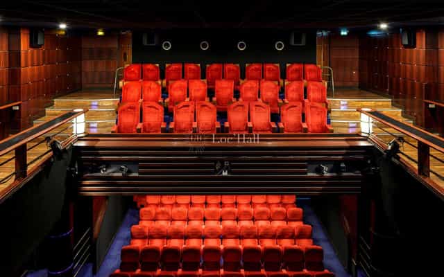 Modern Main Cinema Hall with red seating, ideal for film screenings or private events.