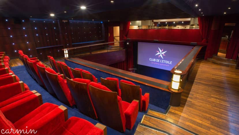 Main Cinema Hall at Club de l’Étoile, featuring red seating for events and screenings.