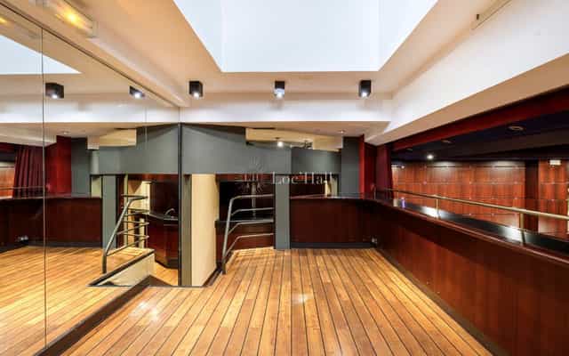 Main Cinema Hall at Club de l’Étoile, modern event space with polished flooring for gatherings.