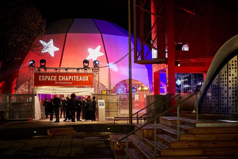 Vibrant event space with colorful tent structure at Espace Chapiteaux in Parc de la Villette.