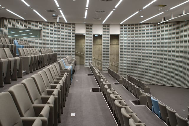 Modern auditorium with tiered seating in Grande Arche for conferences and events.