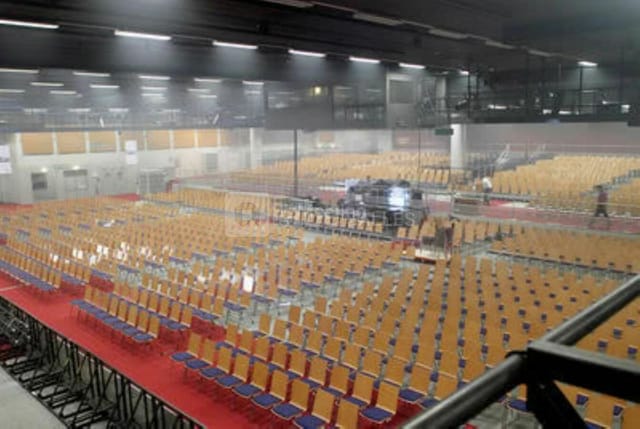 Spacious auditorium in Grande Arche ready for events with empty chairs and mist.