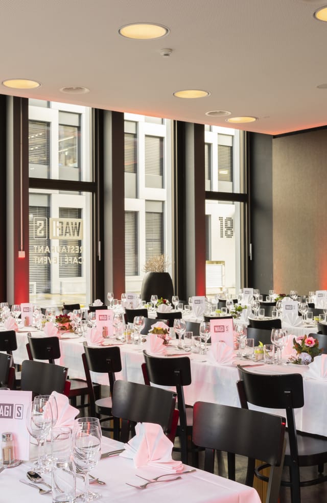 Sophisticated cafe event space with elegant tables, perfect for formal gatherings and corporate events.