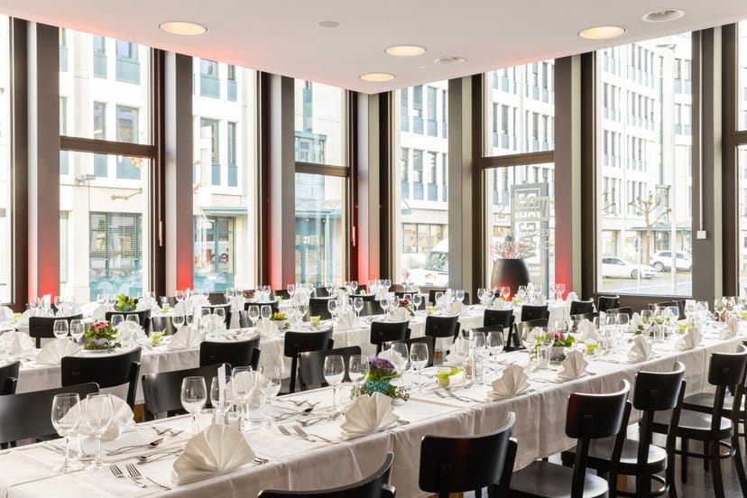 Elegant cafe dining space with floral centerpieces, perfect for formal events and gatherings.