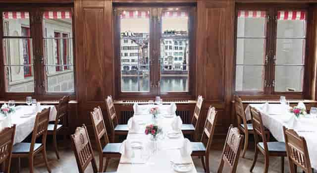 Sophisticated dining space with wooden decor at Zunfthaus zur Zimmerleuten, ideal for events.
