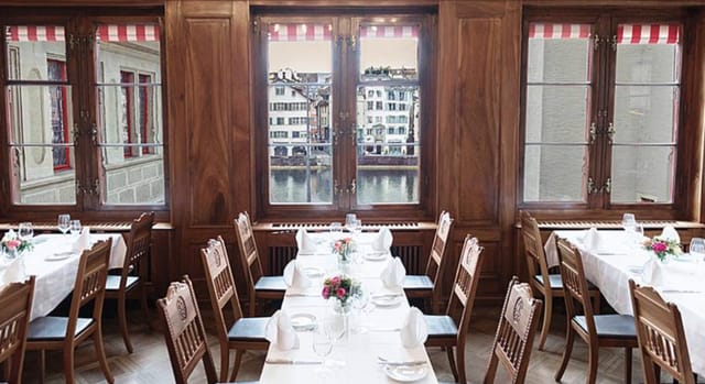 Sophisticated dining space with wooden decor at Zunfthaus zur Zimmerleuten, ideal for events.