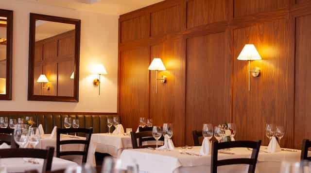 Elegant restaurant interior with soft lighting for corporate dinners and intimate gatherings.