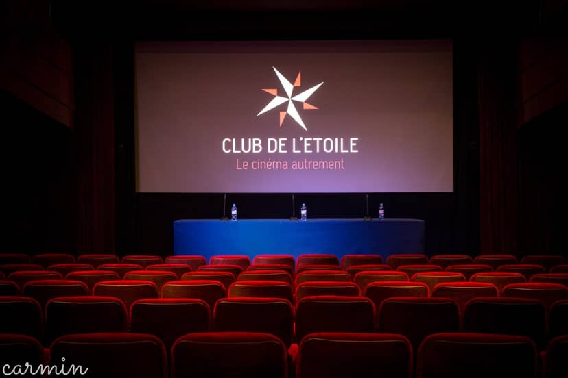 Auditorium at Club de l'Étoile, set for a professional panel discussion event.
