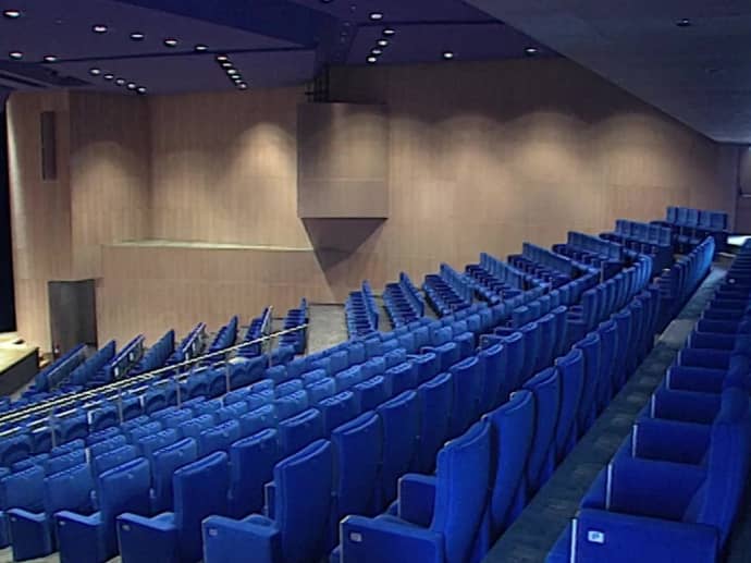 Amphithéâtre Saint Exupéry: modern auditorium with tiered blue seating for conferences, performances.