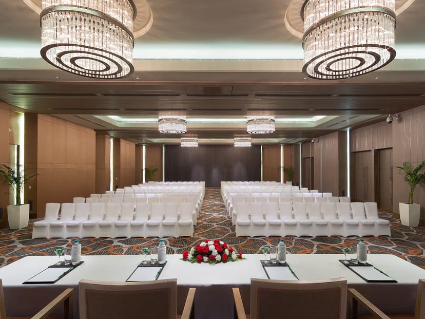 Conference center at Holiday Inn Delhi with white chairs, ideal for meetings and workshops.