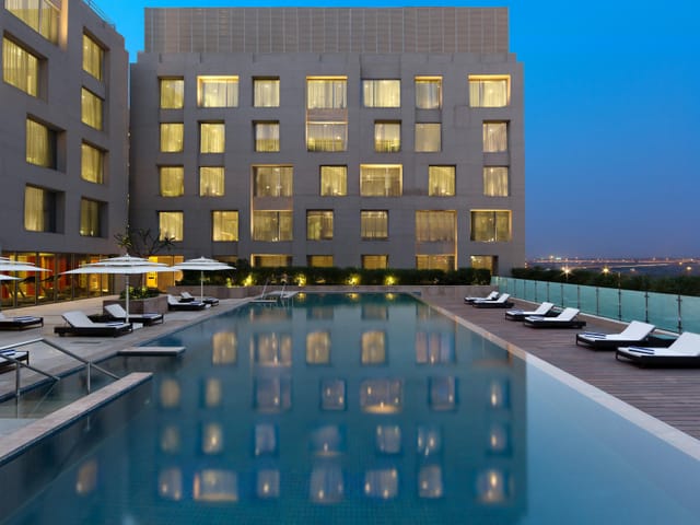 Holiday Inn New Delhi airport conference center pool, modern architecture, event space.