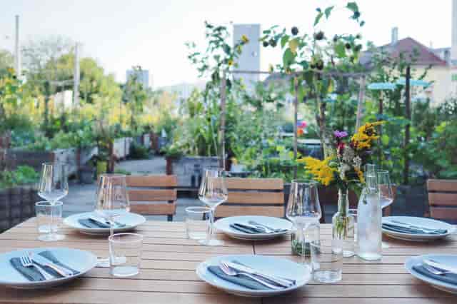 Outdoor dining setup at The Artisan: rustic table, ideal for charming garden events.