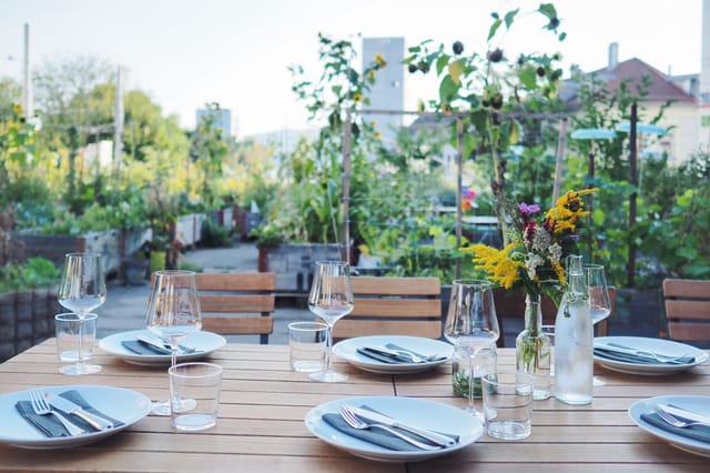 Outdoor dining setup at The Artisan: rustic table, ideal for charming garden events.