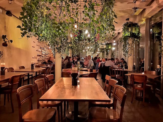 Vibrant restaurant event space with warm lighting, ideal for gatherings and meetings.