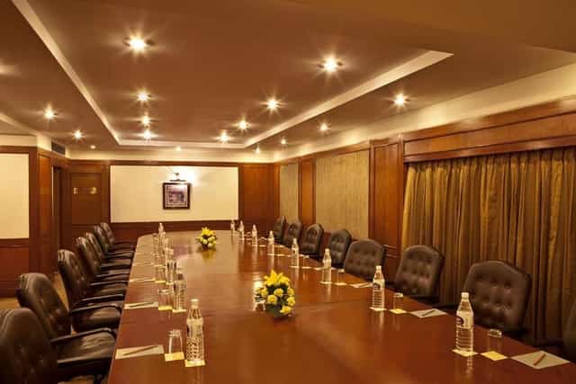 Boardroom at Hotel Hill Stone Residency, polished table and leather chairs for executive meetings.