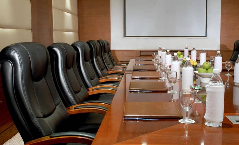 Conference room at Hotel Hill Stone Residency with leather chairs, ideal for executive meetings.