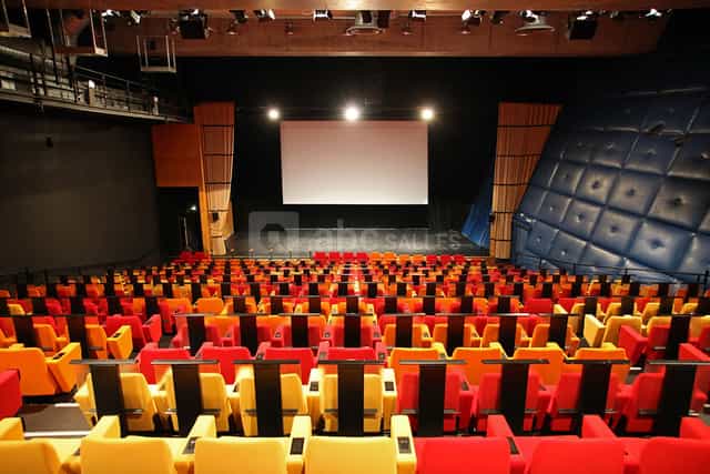 Modern auditorium in Lille Grand Palais with red and yellow seating for events.