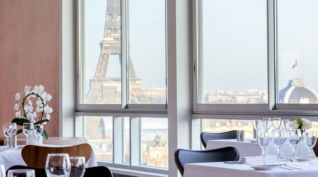 Elegant dining area at UNESCO Restaurant with Eiffel Tower view for corporate events.