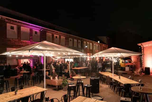 Outdoor event space at Motorwerk Berlin with warm lighting for networking and social gatherings.
