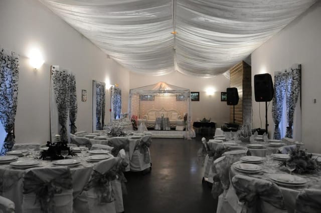 Elegant event space in Salle des fêtes La Courneuve with beautifully set tables for ceremonies.