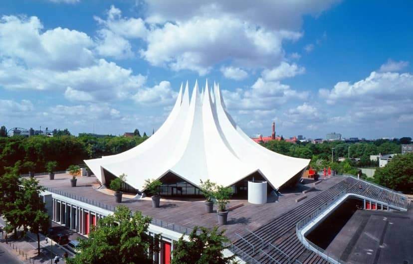 Modern tent structure at Tempodrom for versatile outdoor events in a natural setting.