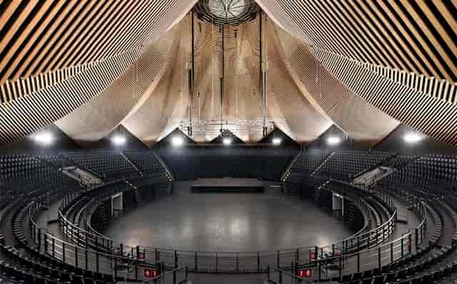 Spacious Tempodrom venue with striking ceiling, perfect for conferences and performances.