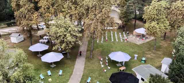 Garden event space at Villa Schützenhof with shaded seating for weddings and retreats.
