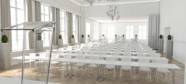 Modern conference room with white furniture, ideal for corporate meetings and seminars.