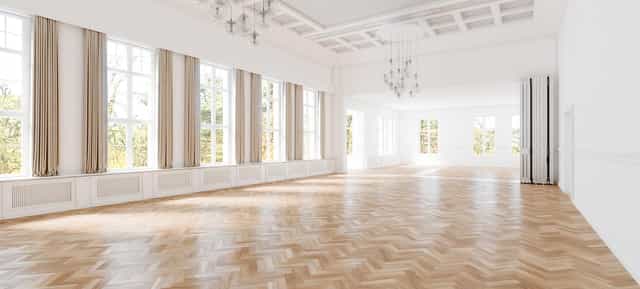 Spacious Villa Schützenhof hall with elegant chandeliers for corporate events and gatherings.