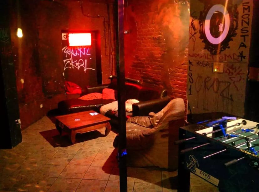 Cozy nightclub meeting space with plush seating, ideal for team-building activities.