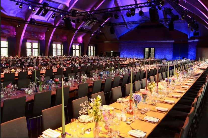 Elegant banquet hall with floral centerpieces in Westhafen Event Center for corporate events.