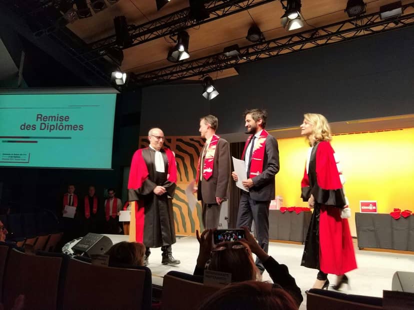 Formal diploma award ceremony at Salle Sainte-Victoire, Aix-en-Provence, with academic attire.