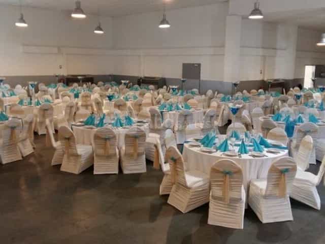 Elegant banquet hall in Bobigny, featuring round tables and white tablecloths for events.
