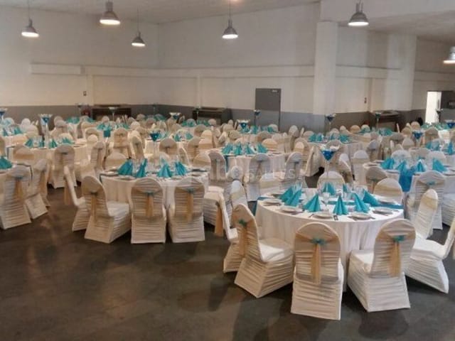 Elegant banquet hall in Bobigny, featuring round tables and white tablecloths for events.