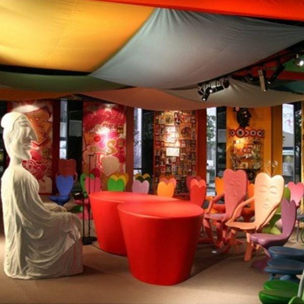 Vibrant event space in Salle Maurice Nilès, featuring colorful decor and artistic seating.