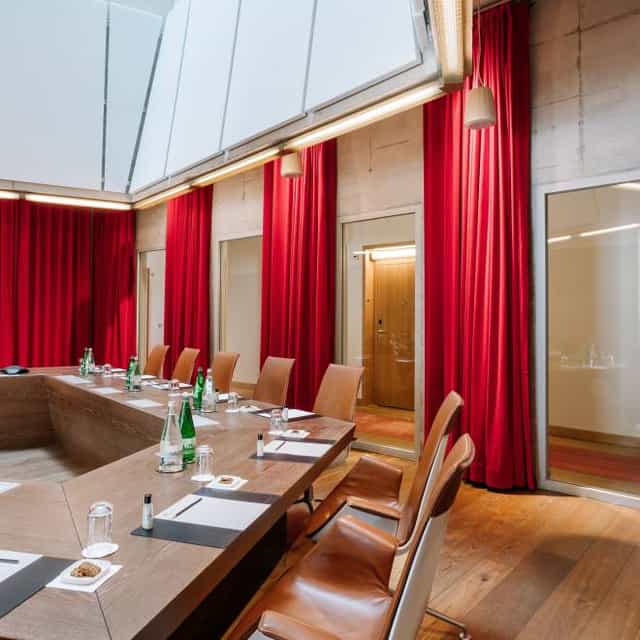 Modern conference room with oval table, ideal for meetings and events.