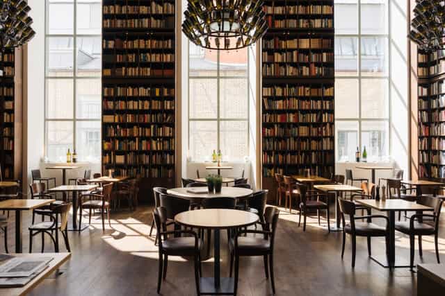 Stylish B2 Hotel meeting room with natural light, ideal for workshops and networking events.