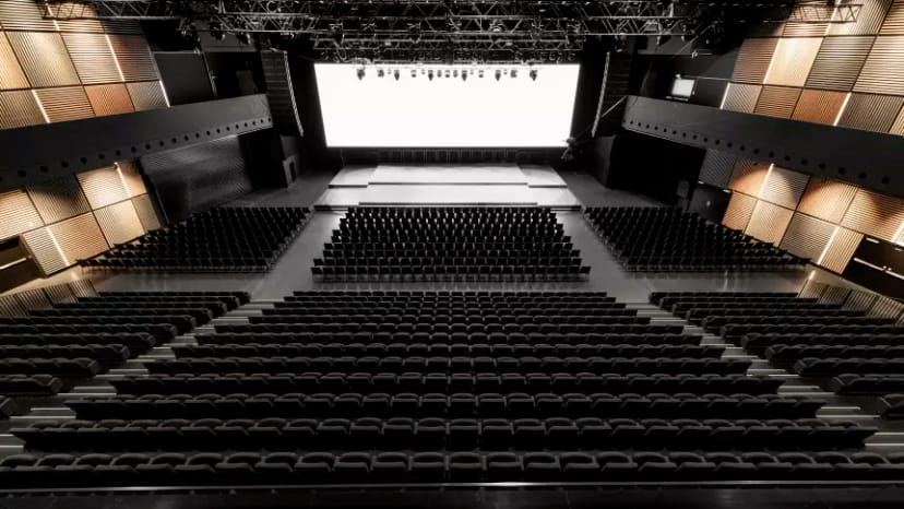 Spacious auditorium with tiered seating for conferences and presentations.