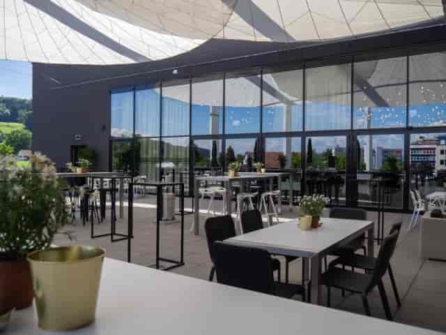 Stylish outdoor event space with modern furnishings and greenery for gatherings.