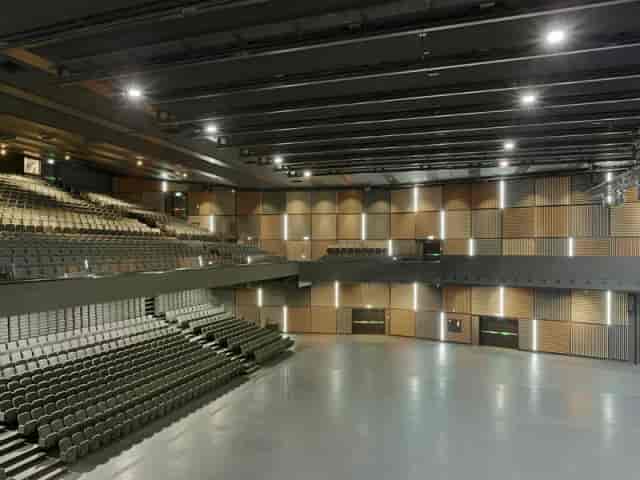 Spacious event venue with tiered seating for versatile conferences and performances.