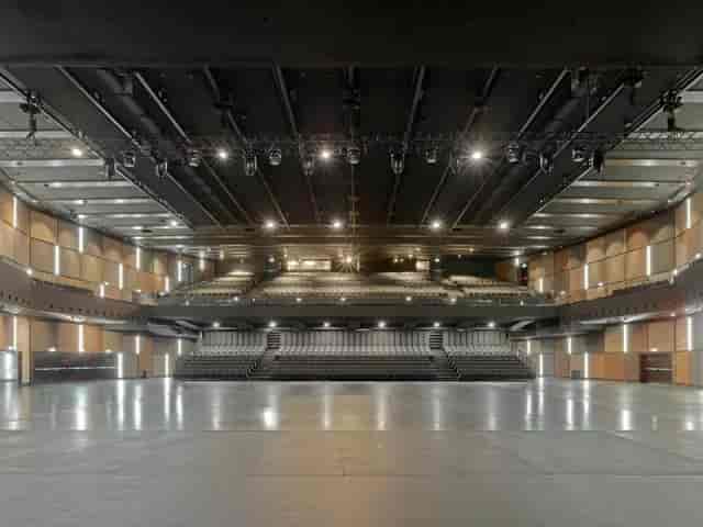 Spacious event venue with modern auditorium, ideal for conferences and performances.
