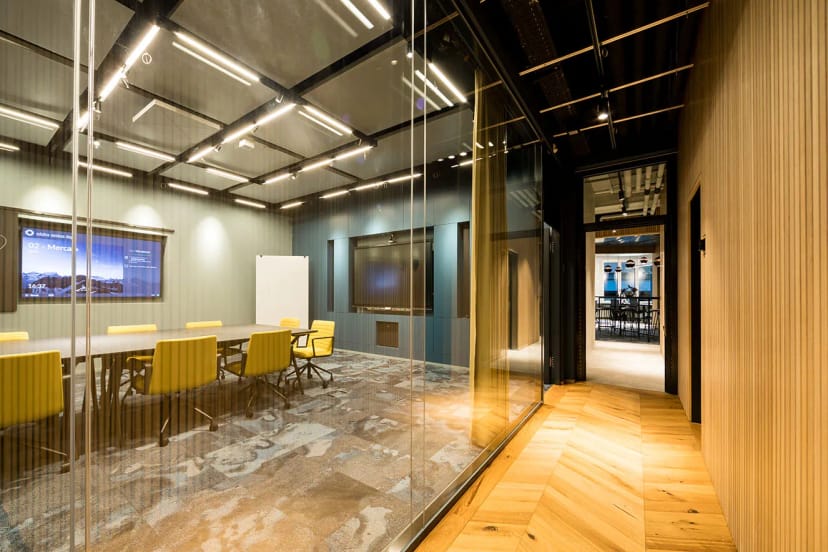 Modern conference room in ACE Zurich with vibrant yellow chairs for meetings and brainstorming.