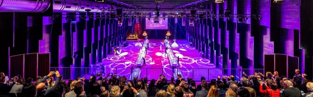 Vibrant foyer in Halle 622, with tiered seating for presentations and fashion shows.