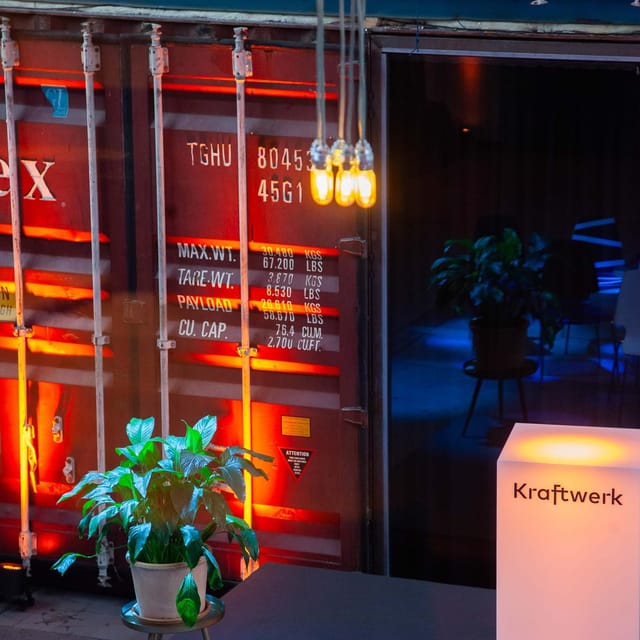 Industrial-themed bar with vibrant lighting, perfect for creative events and gatherings.