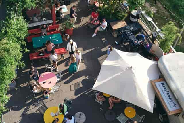 Kraftwerk Terrasse: vibrant outdoor gathering space with colorful tables for events.