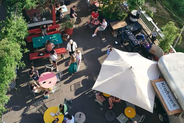Kraftwerk Terrasse: vibrant outdoor gathering space with colorful tables for events.